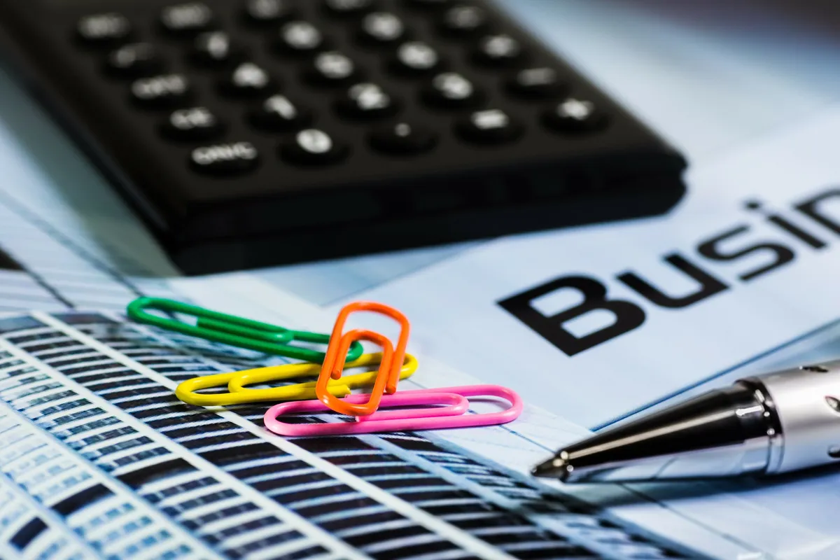 A business owner frustrated over overdue invoices at a desk